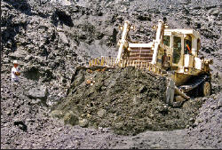 Collecting operation using heavy equipment, note yellow opriment rich zones in the upper photo. Collector’s Edge photo.