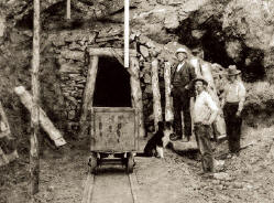 Entrance to the 50 meters long adit in1908. Note camp dog – Fritz. Photo courtesyof Collector’s Edge.