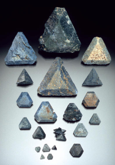 Group of benitoite crystals showing different forms, size up to 4.5 cm. B. Gray specimens. J. Scovil photo.