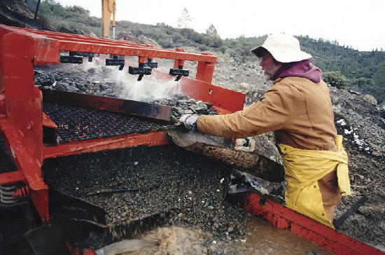 Buzz Gray operating the washer to remove mud. M. Gray photo.